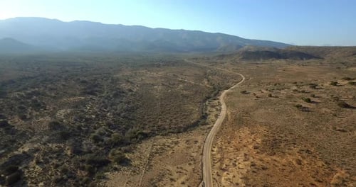 Desert road, highway and aerial view with drone in Arizona with landscape and countryside