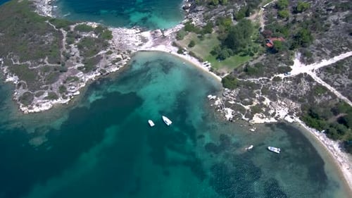 Drone view of a small bay with a magnificent beach and two boats