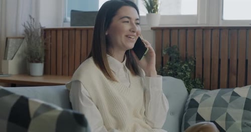 Smiling Brunette Woman Talking on Phone at Home