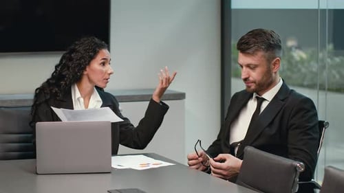 Business Discussion Between Colleagues in a Modern Office Setting