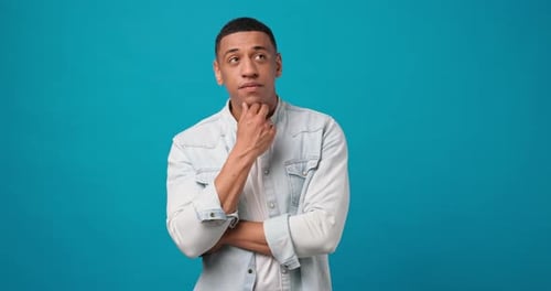 Thoughtful Man Considers Options on Blue Background