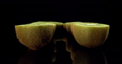 Juicy fresh kiwi fruit cut in half super close up shoot fly over 4k high quallity shoot on dark glos
