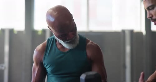 Mature man, dumbbells and weightlifting in gym for exercise, workout or training