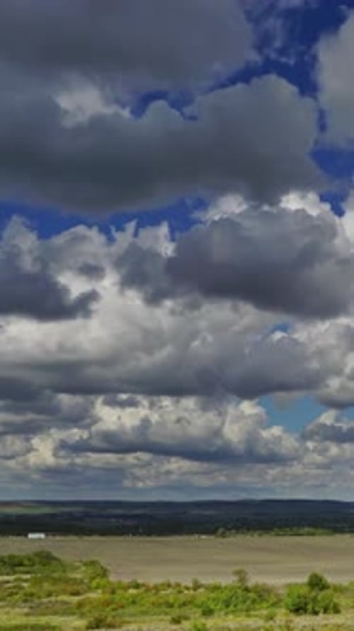 Dramatic Clouds over Rural Landscape and Distant Town