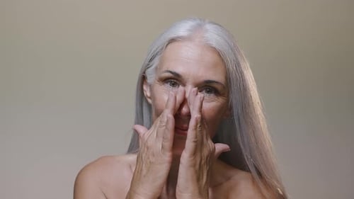 Beautiful senior woman with silver hair beauty session in studio