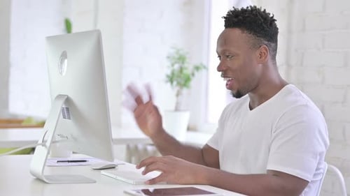 Man Working at Computer on Video Conference