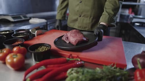 Chef Preparing Meat in a Professional Kitchen