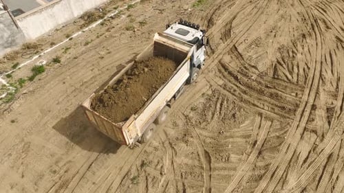 Earth Movers Aerial View of Excavator and Trucks
