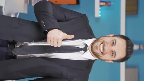 Man Giving Thumbs Up in Office Setting
