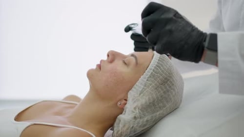 Woman Receives Facial Treatment in Clinic
