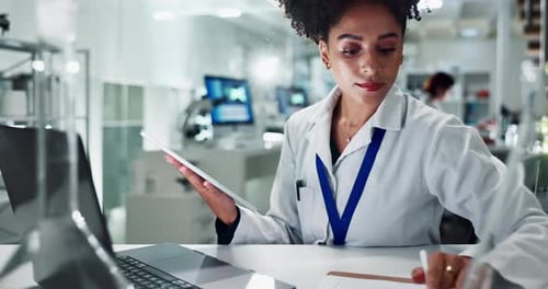 Woman Scientist Using Tablet in a Bright Laboratory