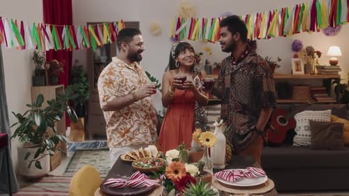 Friends Toasting Drinks at an Indoor Gathering