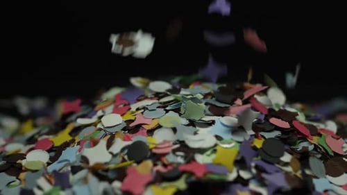 El confeti de papel de colores cae en una pila. Cámara lenta tomada en primer plano sobre un fondo de fondo
.