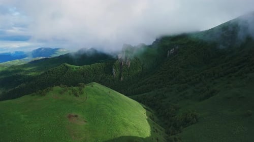 Breathtaking Aerial View of Green Mountains and Dramatic Clouds in Early Morning Light Mount