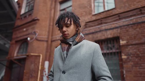Stylish Young Man Posing in an Urban Alleyway