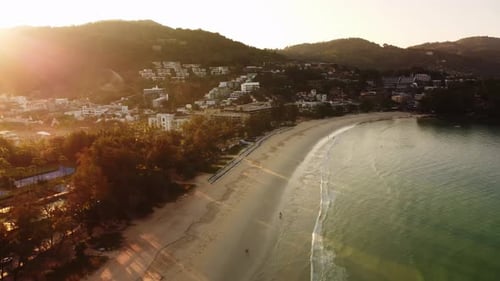 Aerial Landscape of Tropical Sandy Beach Washed By Warm Sea and People Walking Along Waterfront