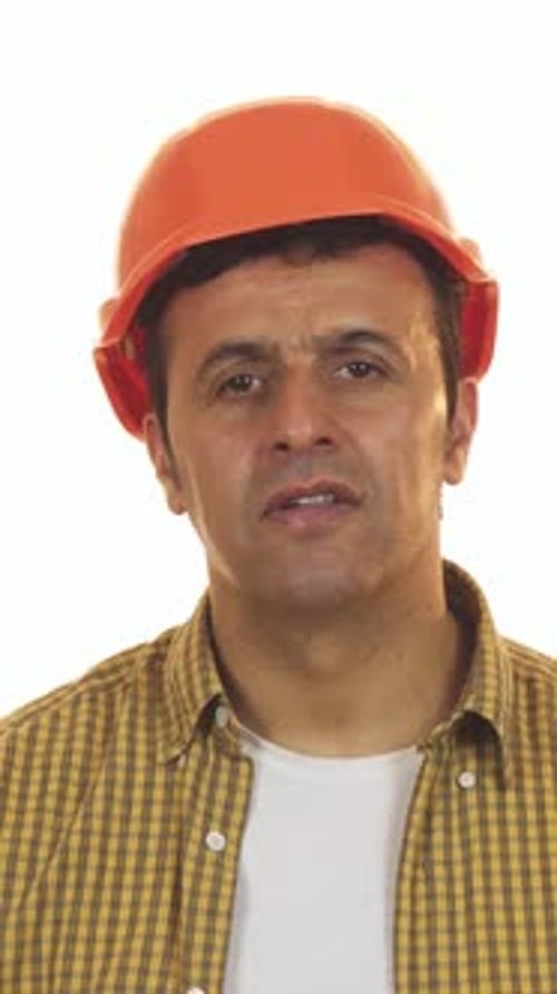 Shocked Construction Worker Removing His Hardhat in Disbelief