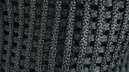 Texture of mesh black fabric, tight weave providing good ventilation. Dolly slider extreme close-up.