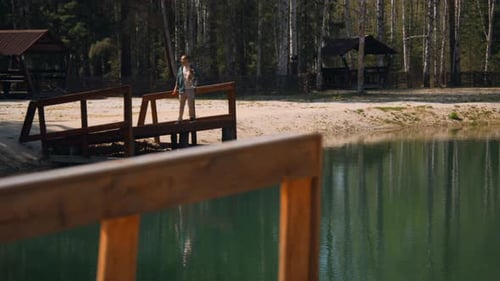 Man with dog on lake pier