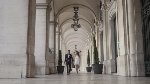 Couple Holding Hands Under Archway