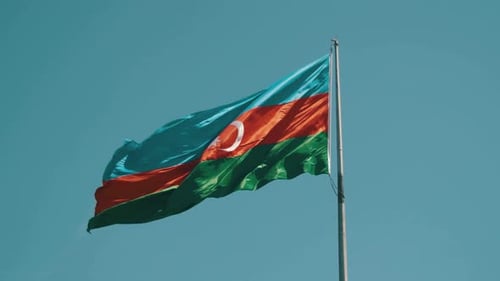 Azerbaijan Flag Waving Proudly Against Blue Sky