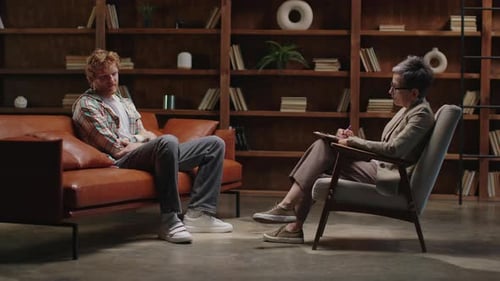 Young Adult Man Talking in Therapy Session