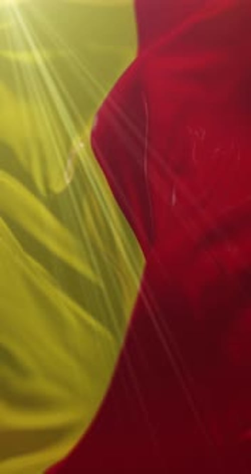 Fluid Waving Red and Yellow Fabric Background Animation with Light Rays