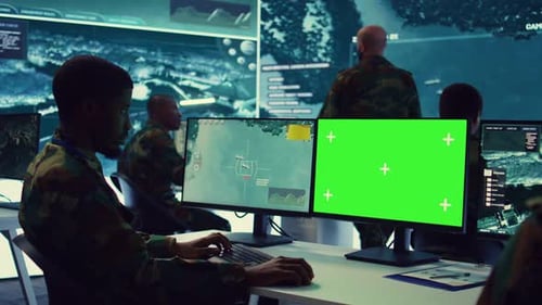 Military Personnel Working at Computers with Green Screen