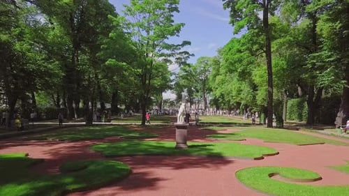 Summer Garden, an aerial drone footage of a beautiful central park with a monument and fountain from