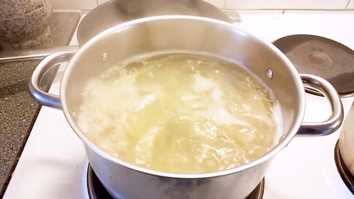 Spaghetti boiling in water in saucepan - Cooking Spaghetti Bolognese