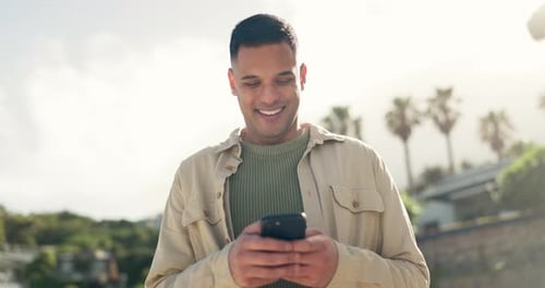 Young Adult Using Phone on Sunny Day