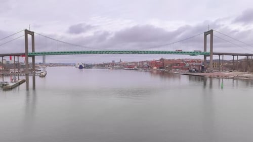 Wide aerial tracking shot of Älvsborg bridge spanning Göta Älv river, Gothenburg