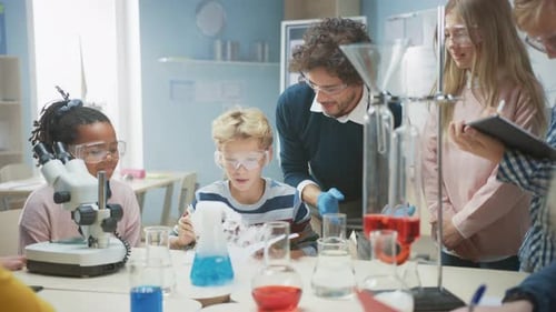 Elementary School Science Classroom: Enthusiastic Teacher Explains Chemistry to Diverse Group of Ch