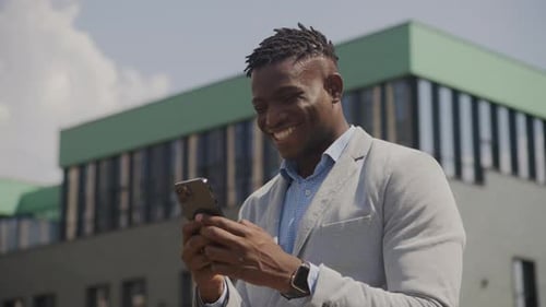 Happy Man Using Smartphone in Urban Setting