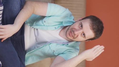Vertical video of The man who is angry at the camera.