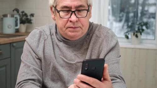 Adult Man Using Smartphone Indoors Close Up