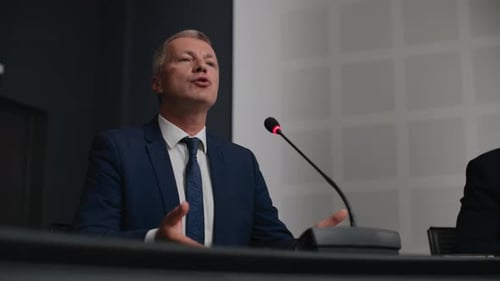 Man Speaks at Corporate Press Conference With Microphone