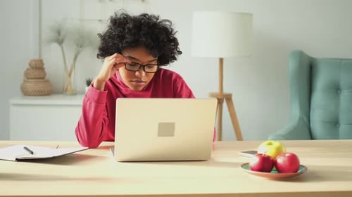 African American Girl Using Laptop at Home Office Looking at Screen Typing Chatting Reading Writing