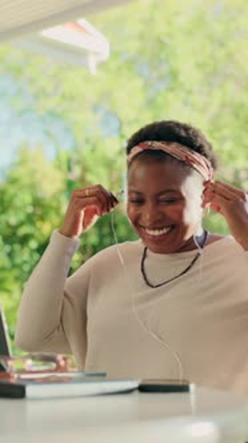 Smiling Woman Video Calling on Laptop at Table