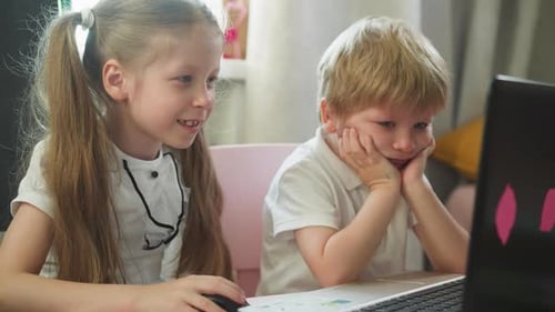 Children Focused on Laptop at Home