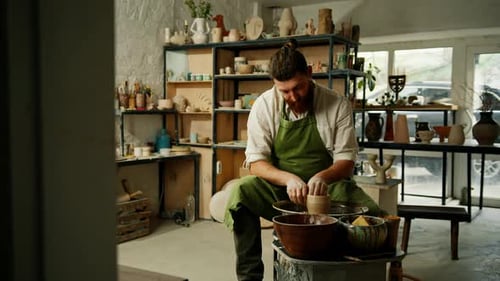 A man makes a clay pot on a ceramic wheel Ceramics Close-up A potter does pottery handicraft