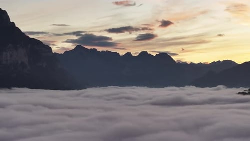 Aerial view of Lake Walensee in Switzerland blanketed by fog and clouds.