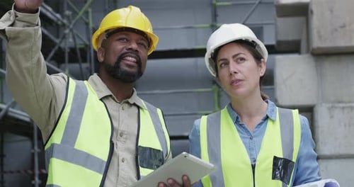 Architects Reviewing Plans at a Construction Site