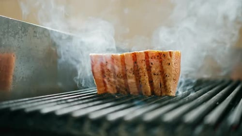 Professional kitchen in hotel restaurant close-up juicy piece of fresh grilled salmon dish texture