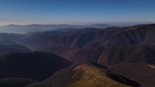 Drone Flies Over Top of the Mount Gemba with Scenic Mountain Range on the Horizon Aerial View of the