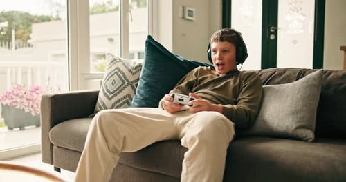 Excited Boy Playing Video Game at Home