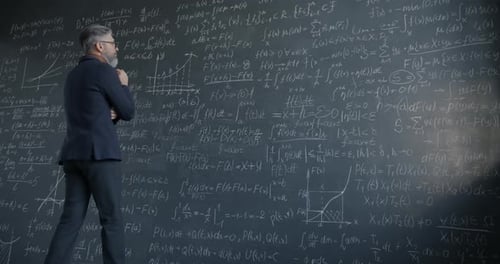 Fast Motion of Man in Suit College Professor Writing on Chalkboard Focused on Science and Research