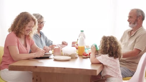Family Together at Table with Food and Juice