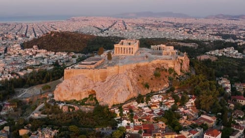 Aerial View Of Acropolis Of Athens On Rocky Outcrop Above City Of Athens In Greece At Sunrise.