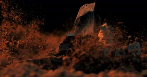 Slow motion close up shot of falling chocolate pieces in cocoa while the ground rotates against a bl